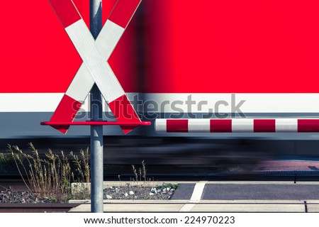 Railway crossing sign and a passing train/Railroad Crossing
