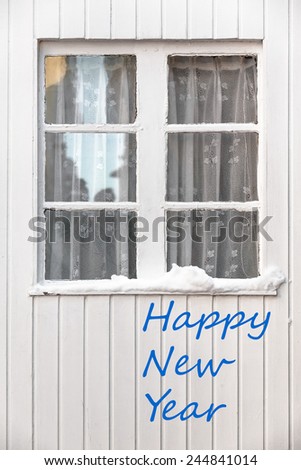 New year greetings with vintage transom window at a white wooden wall in winter/White Wooden Window - Happy New Year