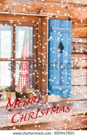 Snowy window detail of a bavarian alps wooden mountain hut with textual holiday message/Window of Bavarian Chalet in Winter - Merry Christmas