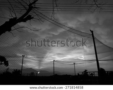 Black and white pattern cloud over football field.