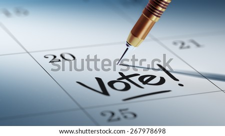 A dart stick on Calendar. Concept image of a Calendar with a shiny golden dart stick. Closeup shot of a dart attached. Vote! text note reminder concept. Words Vote! written in Black Marker.