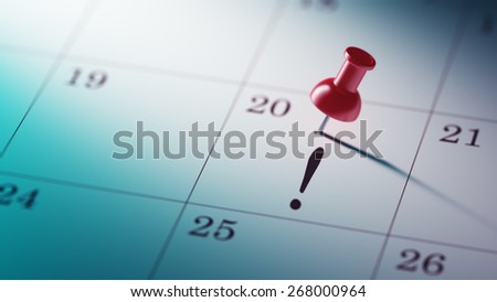 Concept image of a Calendar with a shiny red push pin. Closeup shot of a thumbtack attached.
