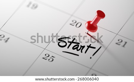 Concept image of a Calendar with a shiny red push pin. Closeup shot of a thumbtack attached. Start text note reminder concept. Words Start written in Black Marker.