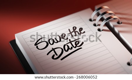 Closeup of a personal agenda marking a day of the month representing a organizing time and schedule. Save the date text note reminder concept. Words Save the date written in Black Marker.