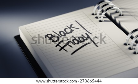 Closeup of a personal agenda setting an important date representing a time schedule. The words Black Friday written on a white notebook to remind you an important appointment.