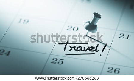 Concept image of a Calendar with a push pin. Closeup shot of a thumbtack attached. The words Travel written on a white notebook to remind you an important appointment.