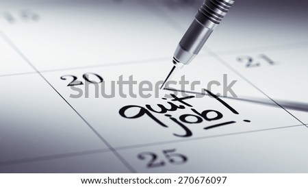 Concept image of a Calendar with a golden dart stick. The words Quit job written on a white notebook to remind you an important appointment.