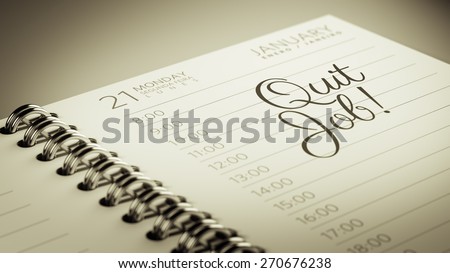 Closeup of a personal calendar setting an important date representing a time schedule. The words Quit job written on a white notebook to remind you an important appointment.
