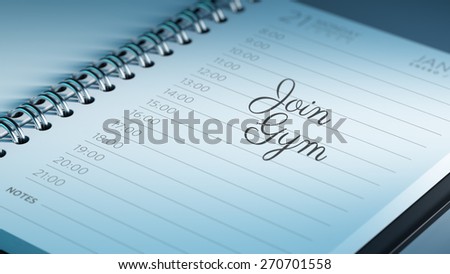 Closeup of a personal calendar setting an important date representing a time schedule. The words Join GYM written on a white notebook to remind you an important appointment.