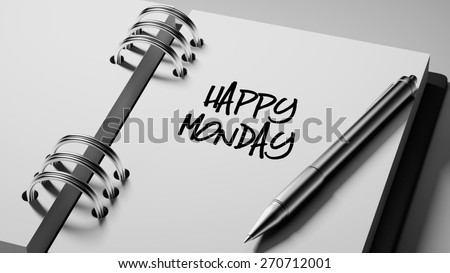 Closeup of a personal agenda setting an important date writing with pen. The words Happy Monday written on a white notebook to remind you an important appointment.