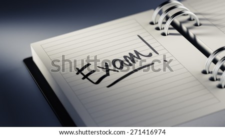 Closeup of a personal agenda setting an important date representing a time schedule. The words Exam written on a white notebook to remind you an important appointment.