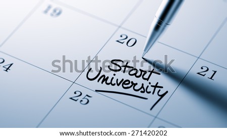 Closeup of a personal agenda setting an important date written with pen. The words Start University written on a white notebook to remind you an important appointment.