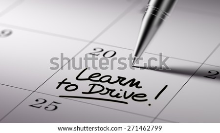 Closeup of a personal agenda setting an important date written with pen. The words Learn to Drive written on a white notebook to remind you an important appointment.
