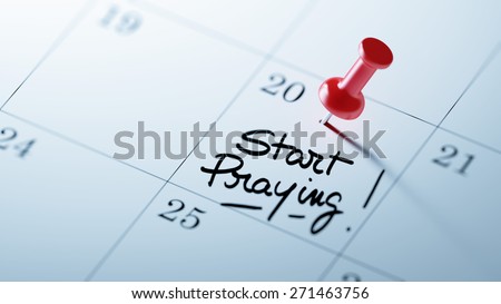 Concept image of a Calendar with a red push pin. Closeup shot of a thumbtack attached. The words Start Praying written on a white notebook to remind you an important appointment.
