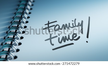Closeup of a personal calendar setting an important date representing a time schedule. The words Family Time written on a white notebook to remind you an important appointment.
