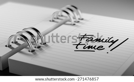 Closeup of a personal agenda setting an important date representing a time schedule. The words Family Time written on a white notebook to remind you an important appointment.