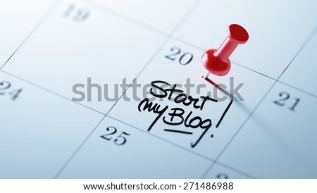 Concept image of a Calendar with a red push pin. Closeup shot of a thumbtack attached. The words Start my Blog written on a white notebook to remind you an important appointment.