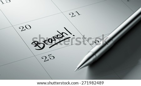 Closeup of a personal agenda setting an important date written with pen. The words Branch written on a white notebook to remind you an important appointment.