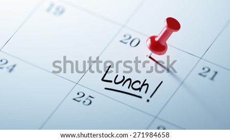 Concept image of a Calendar with a red push pin. Closeup shot of a thumbtack attached. The words Lunch written on a white notebook to remind you an important appointment.