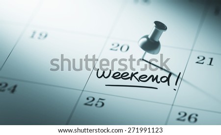 Concept image of a Calendar with a push pin. Closeup shot of a thumbtack attached. The words Weekend written on a white notebook to remind you an important appointment.