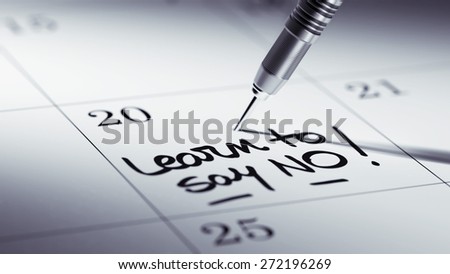 Concept image of a Calendar with a golden dart stick. The words Learn to say no written on a white notebook to remind you an important appointment.