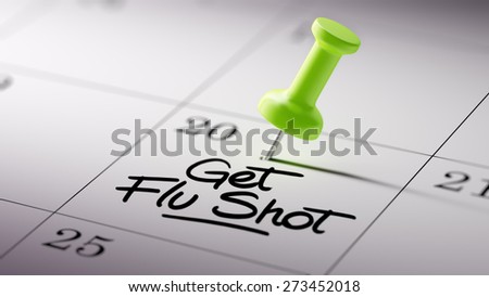 Concept image of a Calendar with a green push pin. Closeup shot of a thumbtack attached. The words Get Flu Shot written on a white notebook to remind you an important appointment.
