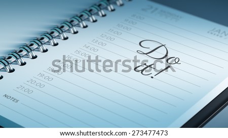 Closeup of a personal calendar setting an important date representing a time schedule. The words Do it written on a white notebook to remind you an important appointment.