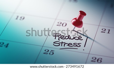 Concept image of a Calendar with a red push pin. Closeup shot of a thumbtack attached. The words Reduce Stress written on a white notebook to remind you an important appointment.