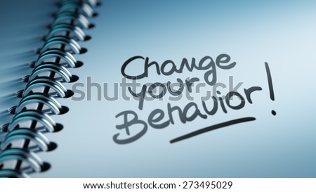 Closeup of a personal calendar setting an important date representing a time schedule. The words Change your behavior written on a white notebook to remind you an important appointment.