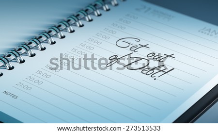 Closeup of a personal calendar setting an important date representing a time schedule. The words Get out of debt written on a white notebook to remind you an important appointment.