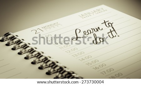 Closeup of a personal calendar setting an important date representing a time schedule. The words Learn to do it written on a white notebook to remind you an important appointment.