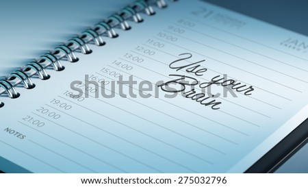 Closeup of a personal calendar setting an important date representing a time schedule. The words Use your Brain written on a white notebook to remind you an important appointment.
