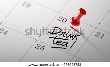 Concept image of a Calendar with a red push pin. Closeup shot of a thumbtack attached. The words Drink Tea written on a white notebook to remind you an important appointment.