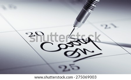 Concept image of a Calendar with a golden dart stick. The words Carry on written on a white notebook to remind you an important appointment.