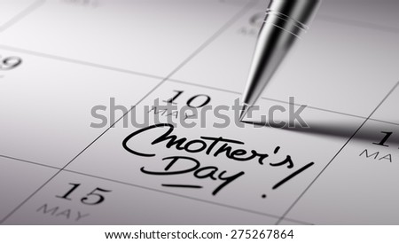 Closeup of a personal agenda setting an important date written with pen. The words Mother\'s Day written on a white notebook to remind you an important appointment.