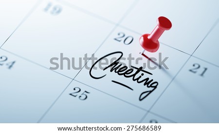 Concept image of a Calendar with a red push pin. Closeup shot of a thumbtack attached. The words Meeting written on a white notebook to remind you an important appointment.