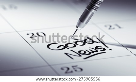 Concept image of a Calendar with a golden dart stick. The words Good News written on a white notebook to remind you an important appointment.