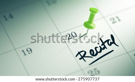 Concept image of a Calendar with a green push pin. Closeup shot of a thumbtack attached. The words Recital written on a white notebook to remind you an important appointment.