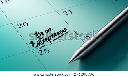 Closeup of a personal agenda setting an important date written with pen. The words Be an entrepreneur written on a white notebook to remind you an important appointment.