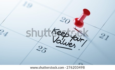 Concept image of a Calendar with a red push pin. Closeup shot of a thumbtack attached. The words Keep your Values written on a white notebook to remind you an important appointment.
