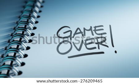 Closeup of a personal calendar setting an important date representing a time schedule. The words Game over written on a white notebook to remind you an important appointment.