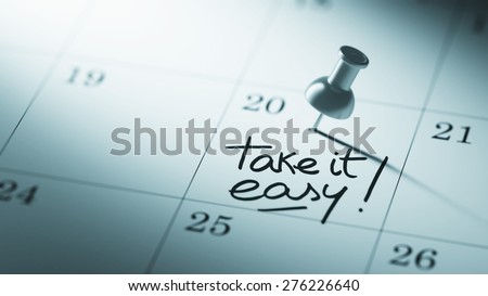Concept image of a Calendar with a push pin. Closeup shot of a thumbtack attached. The words Take it easy written on a white notebook to remind you an important appointment.