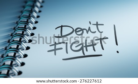 Closeup of a personal calendar setting an important date representing a time schedule. The words Don\'t Fight written on a white notebook to remind you an important appointment.
