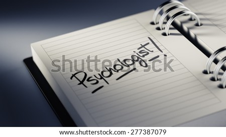 Closeup of a personal agenda setting an important date representing a time schedule. The words Psychologist written on a white notebook to remind you an important appointment.