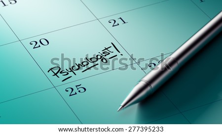 Closeup of a personal agenda setting an important date written with pen. The words Psychologist written on a white notebook to remind you an important appointment.