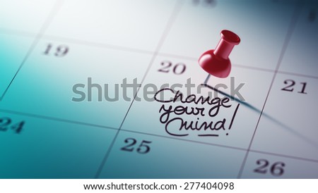 Concept image of a Calendar with a red push pin. Closeup shot of a thumbtack attached. The words Change your Mind written on a white notebook to remind you an important appointment.