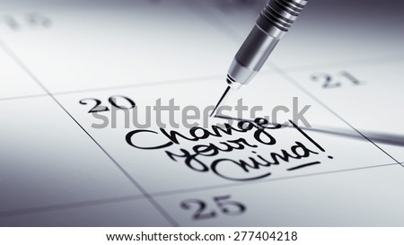 Concept image of a Calendar with a golden dart stick. The words Change your Mind written on a white notebook to remind you an important appointment.