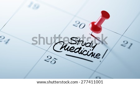 Concept image of a Calendar with a red push pin. Closeup shot of a thumbtack attached. The words Study Medicine written on a white notebook to remind you an important appointment.