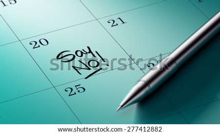 Closeup of a personal agenda setting an important date written with pen. The words Say NO written on a white notebook to remind you an important appointment.