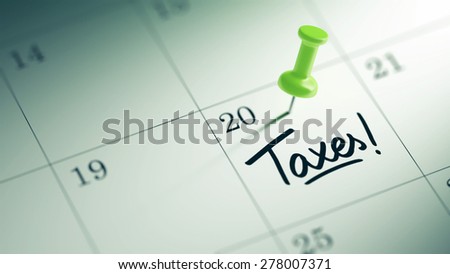 Concept image of a Calendar with a green push pin. Closeup shot of a thumbtack attached. The words Taxes written on a white notebook to remind you an important appointment.